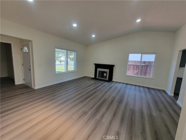 12922 Glenmere Dr, Moreno Valley, CA 92553 - unfurnished living room featuring a fireplace, wood finished floors, recessed lighting, and lofted ceiling