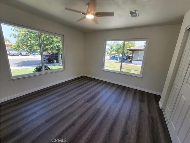 12922 Glenmere Dr, Moreno Valley, CA 92553 - unfurnished bedroom with multiple windows, dark wood-style flooring, and ceiling fan