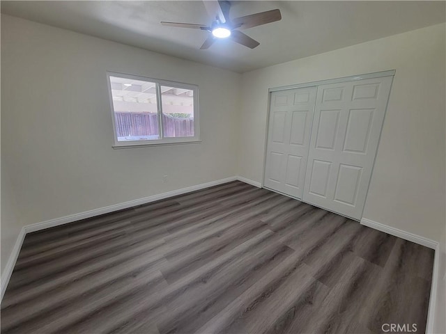 12922 Glenmere Dr, Moreno Valley, CA 92553 - unfurnished bedroom featuring dark wood finished floors, a closet, and a ceiling fan