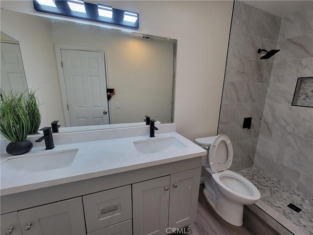 12922 Glenmere Dr, Moreno Valley, CA 92553 - bathroom featuring double vanity, tiled shower, and wood finished floors