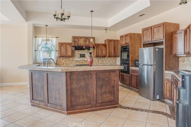 11110 Choctaw Dr, Bakersfield, CA 93308 - kitchen with stainless steel appliances, light tile patterned floors, extractor fan, a raised ceiling, and light countertops