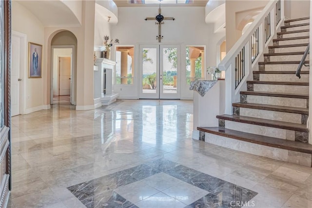 11110 Choctaw Dr, Bakersfield, CA 93308 - foyer with marble tiled floors, stairs, french doors, a towering ceiling, and arched walkways
