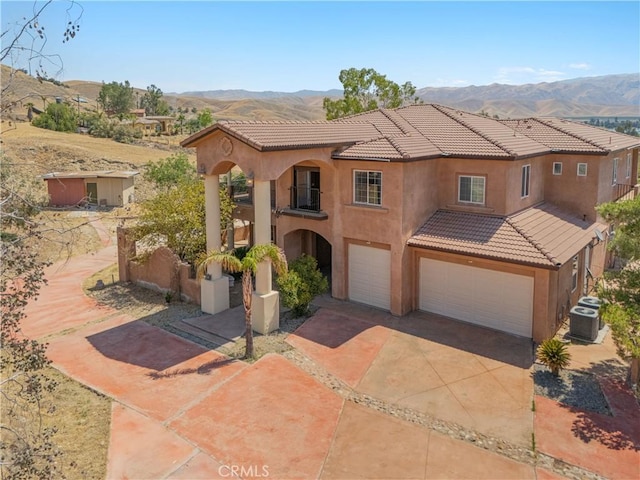 11110 Choctaw Dr, Bakersfield, CA 93308 - mediterranean / spanish home with an attached garage, a tiled roof, concrete driveway, and a mountain view