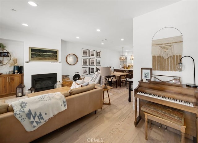 1212 Carmel St, San Luis Obispo, CA 93401 - living room featuring light wood finished floors, a glass covered fireplace, and recessed lighting