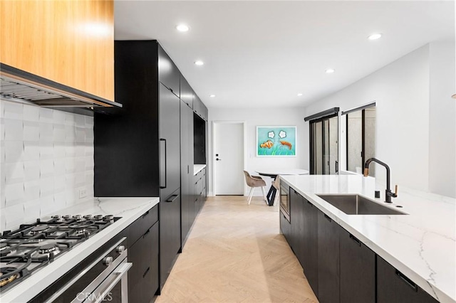 45 Morena, Irvine, CA 92612 - kitchen featuring dark cabinetry, modern cabinets, tasteful backsplash, light stone countertops, and recessed lighting
