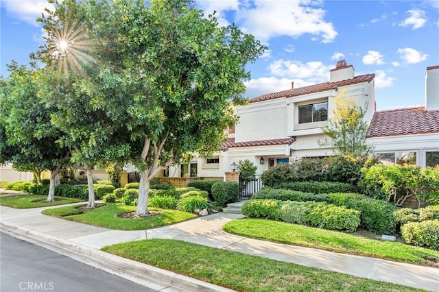 45 Morena, Irvine, CA 92612 - view of front of property featuring a tiled roof, stucco siding, and a chimney