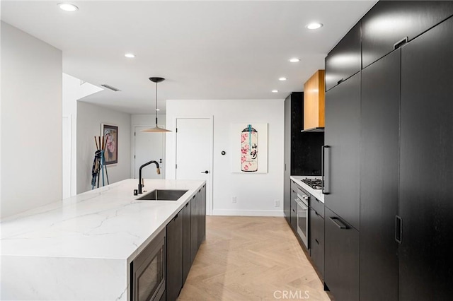 45 Morena, Irvine, CA 92612 - kitchen with appliances with stainless steel finishes, modern cabinets, recessed lighting, decorative light fixtures, and a kitchen island with sink