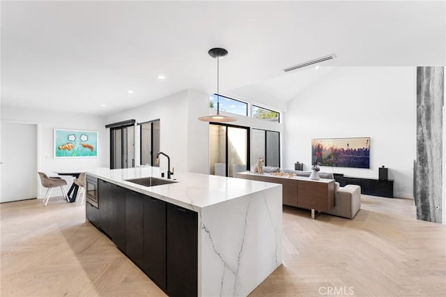 45 Morena, Irvine, CA 92612 - kitchen featuring a center island with sink, modern cabinets, hanging light fixtures, recessed lighting, and light stone counters