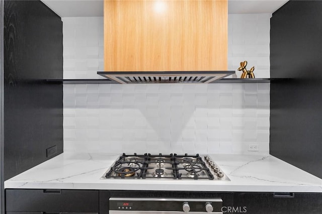 45 Morena, Irvine, CA 92612 - kitchen featuring stainless steel gas cooktop, backsplash, oven, and light stone counters