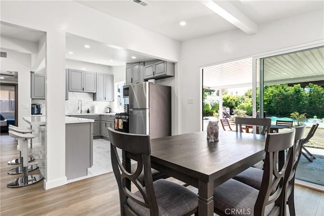 6535 Mary Ellen Ave, Valley Glen, CA 91401 - dining area with healthy amount of natural light, beamed ceiling, light wood finished floors, and recessed lighting