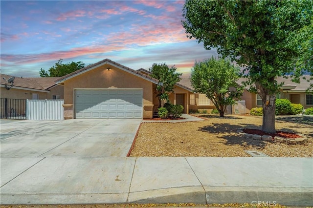 43733 6th St E, Lancaster, CA 93535 - ranch-style house with a garage, stucco siding, driveway, and a tiled roof