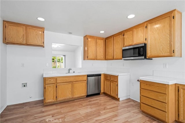 43733 6th St E, Lancaster, CA 93535 - kitchen featuring appliances with stainless steel finishes, light wood-type flooring, recessed lighting, light countertops, and brown cabinets