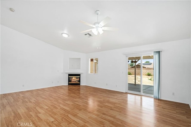 43733 6th St E, Lancaster, CA 93535 - unfurnished living room with lofted ceiling, ceiling fan, light wood-type flooring, and a glass covered fireplace