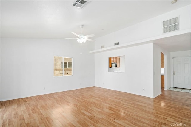 43733 6th St E, Lancaster, CA 93535 - empty room featuring arched walkways, ceiling fan, light wood-style flooring, and high vaulted ceiling