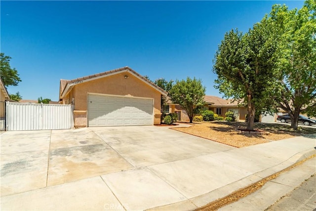 43733 6th St E, Lancaster, CA 93535 - single story home featuring stucco siding, a garage, concrete driveway, a gate, and a tiled roof