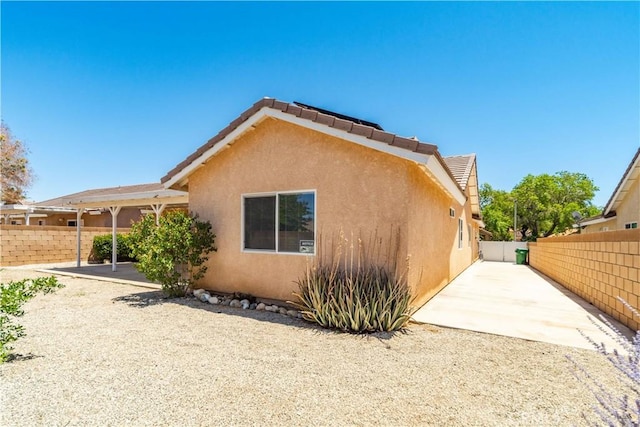43733 6th St E, Lancaster, CA 93535 - view of side of home with stucco siding and a patio