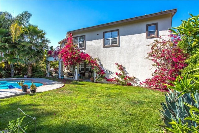 512 Golden W Dr, Redlands, CA 92373 - rear view of property with stucco siding, a yard, a patio area, and an outdoor pool