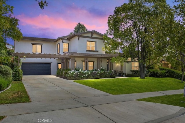 512 Golden W Dr, Redlands, CA 92373 - view of front of home with stucco siding, concrete driveway, a lawn, and an attached garage