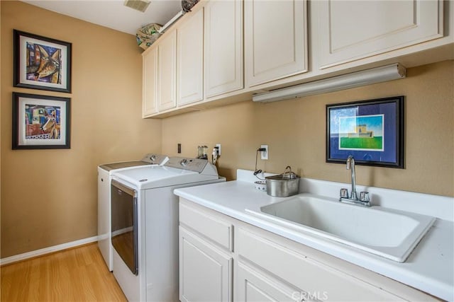 512 Golden W Dr, Redlands, CA 92373 - laundry area with cabinet space, washer and clothes dryer, and light wood finished floors