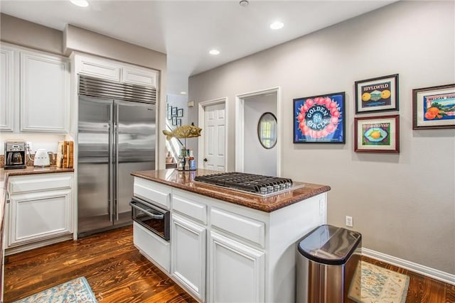 512 Golden W Dr, Redlands, CA 92373 - kitchen with appliances with stainless steel finishes, a warming drawer, dark stone countertops, dark wood-style floors, and recessed lighting