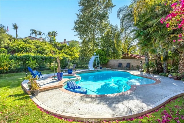 512 Golden W Dr, Redlands, CA 92373 - view of swimming pool featuring a water slide, a patio area, a pool with connected hot tub, and a fenced backyard
