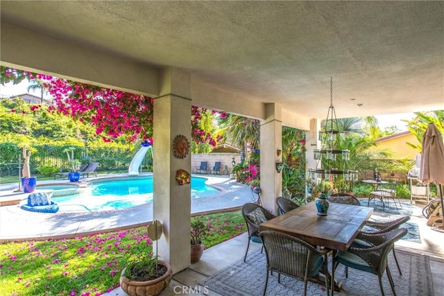 512 Golden W Dr, Redlands, CA 92373 - fenced backyard featuring outdoor dining space, a patio area, and an in-ground hot tub
