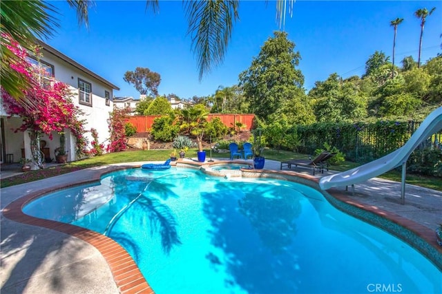 512 Golden W Dr, Redlands, CA 92373 - view of pool featuring a water slide, a fenced backyard, a pool with connected hot tub, and a patio