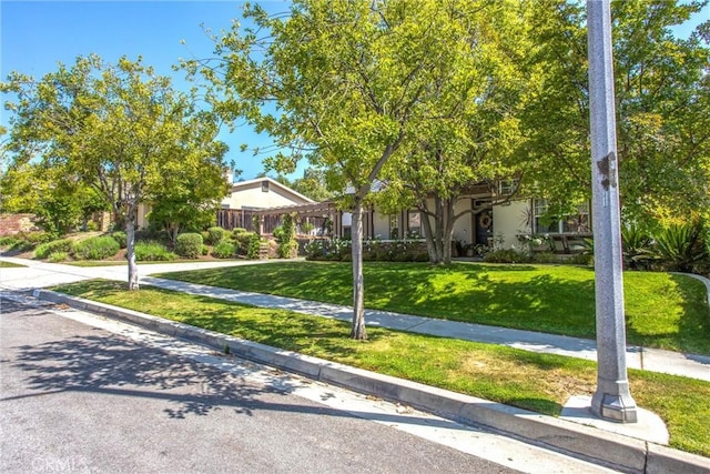 512 Golden W Dr, Redlands, CA 92373 - view of property hidden behind natural elements featuring a front lawn and stucco siding