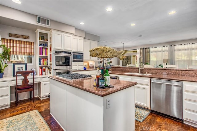 512 Golden W Dr, Redlands, CA 92373 - kitchen featuring stainless steel appliances, recessed lighting, white cabinetry, dark wood finished floors, and dark stone countertops