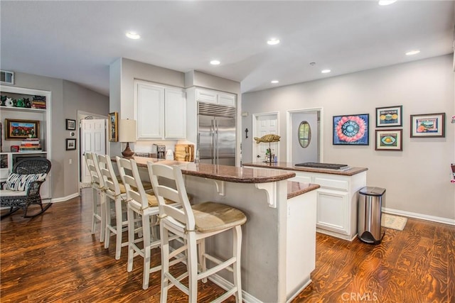 512 Golden W Dr, Redlands, CA 92373 - kitchen featuring appliances with stainless steel finishes, a peninsula, a breakfast bar area, dark wood finished floors, and recessed lighting