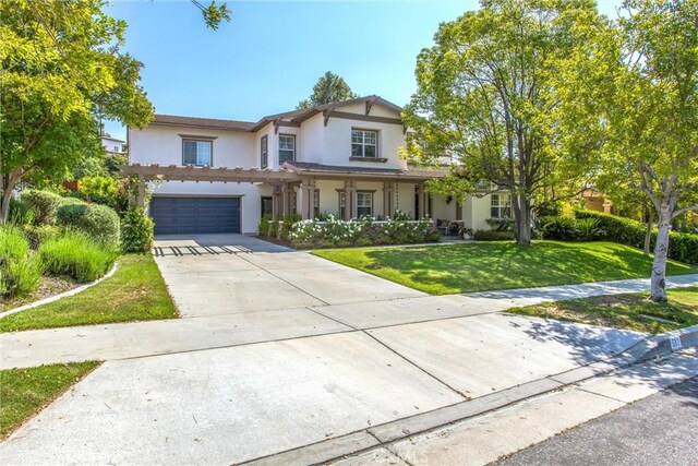 512 Golden W Dr, Redlands, CA 92373 - traditional-style house featuring stucco siding, a front lawn, driveway, and an attached garage