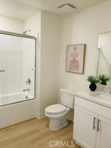 1810 E 1st St Unit 170, Santa Ana, CA 92705 - bathroom with vanity, wood finished floors, and combined bath / shower with glass door