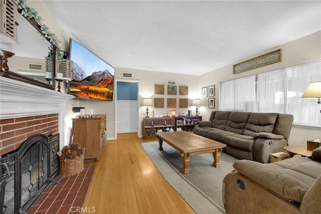 15902 Santa Fe St, Whittier, CA 90603 - living room with a brick fireplace, a textured ceiling, and wood finished floors