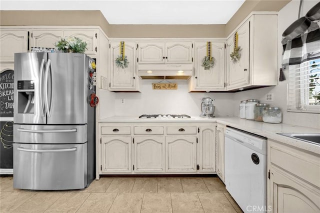 15902 Santa Fe St, Whittier, CA 90603 - kitchen with white appliances, under cabinet range hood, light countertops, and light tile patterned flooring
