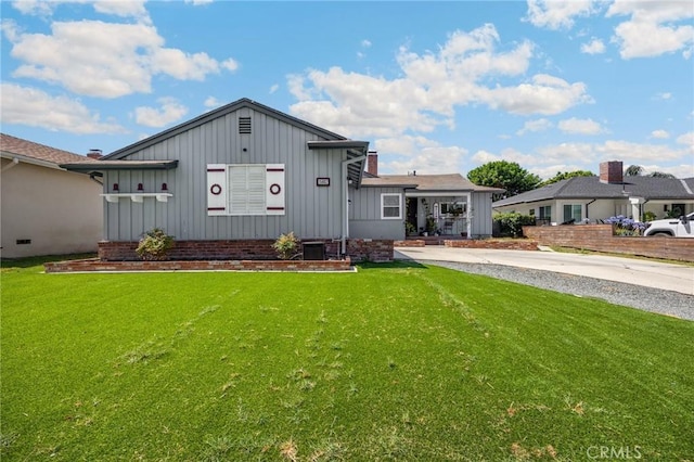 15902 Santa Fe St, Whittier, CA 90603 - view of front of home featuring board and batten siding, a front yard, and a chimney