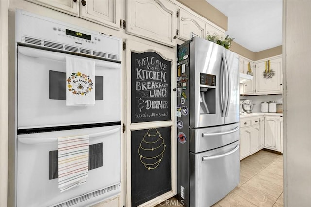 15902 Santa Fe St, Whittier, CA 90603 - kitchen with stainless steel fridge, white double oven, light tile patterned floors, and light countertops
