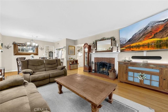 15902 Santa Fe St, Whittier, CA 90603 - living room with light wood finished floors, a chandelier, and a fireplace