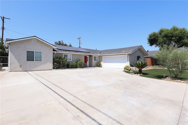 19615 E Tudor St, Covina, CA 91724 - ranch-style home featuring concrete driveway, stucco siding, roof mounted solar panels, and a garage