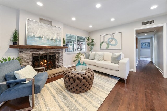 19615 E Tudor St, Covina, CA 91724 - living room featuring dark wood-type flooring, recessed lighting, and a stone fireplace