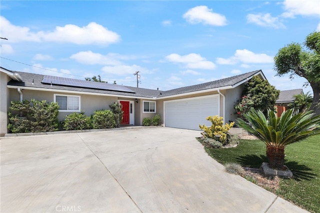 19615 E Tudor St, Covina, CA 91724 - ranch-style home with stucco siding, concrete driveway, a garage, solar panels, and a front lawn