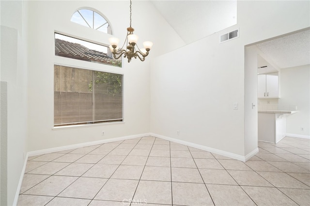 11500 Winery Dr, Fontana, CA 92337 - empty room with light tile patterned floors, a chandelier, and high vaulted ceiling