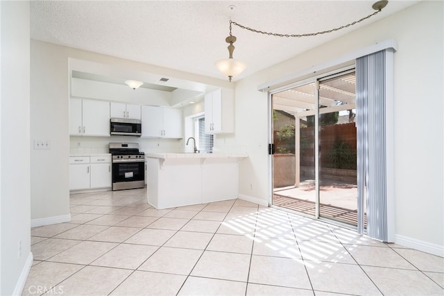 11500 Winery Dr, Fontana, CA 92337 - kitchen featuring stainless steel appliances, light countertops, a peninsula, white cabinets, and pendant lighting