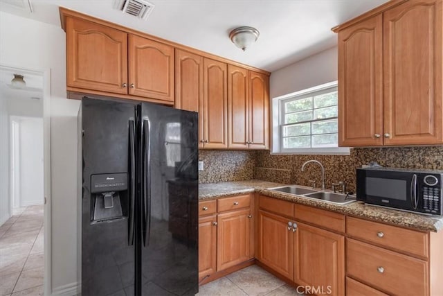 18713 Vanowen St, Reseda, CA 91335 - kitchen featuring black appliances, light tile patterned floors, decorative backsplash, and brown cabinetry