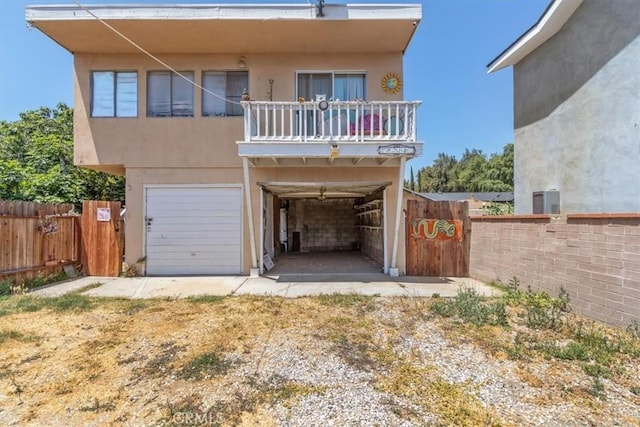 18713 Vanowen St, Reseda, CA 91335 - view of front of home featuring a balcony, a garage, and stucco siding