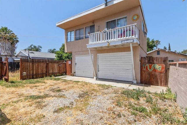 18713 Vanowen St, Reseda, CA 91335 - view of front facade featuring a balcony, a garage, and stucco siding
