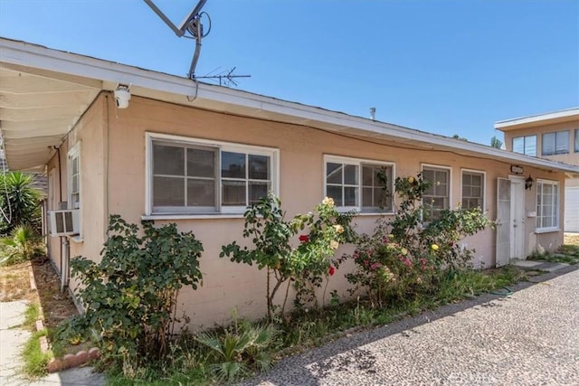 18713 Vanowen St, Reseda, CA 91335 - view of side of home with cooling unit and stucco siding
