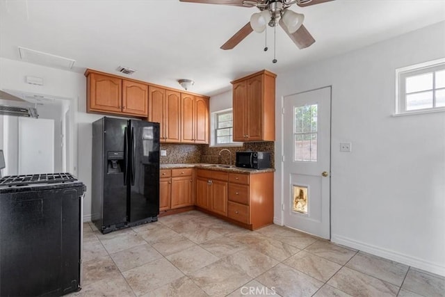 18713 Vanowen St, Reseda, CA 91335 - kitchen featuring black appliances, a ceiling fan, tasteful backsplash, brown cabinetry, and extractor fan