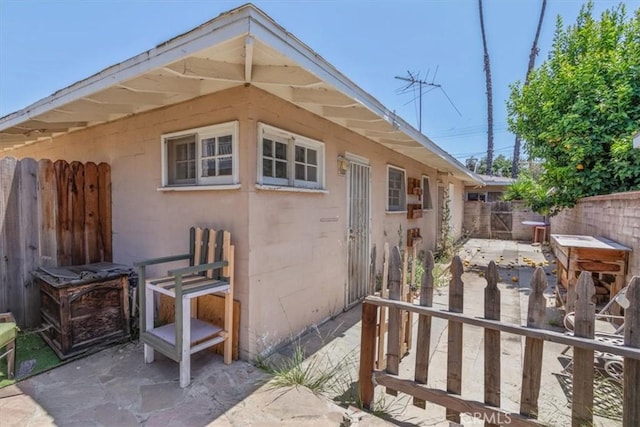 18713 Vanowen St, Reseda, CA 91335 - view of side of home with concrete block siding and a patio