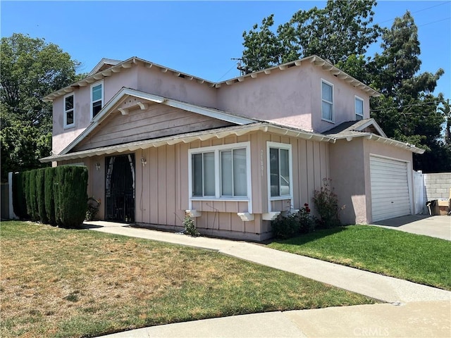 21801 Foley Ave, Carson, CA 90745 - view of front of property featuring board and batten siding, driveway, an attached garage, and stucco siding