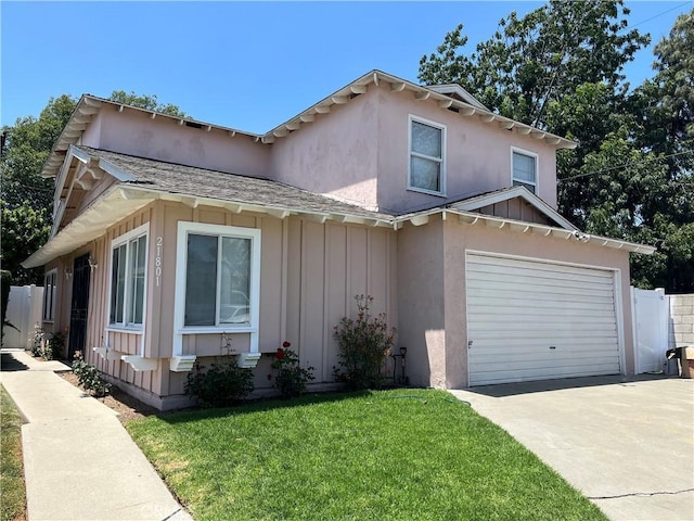 21801 Foley Ave, Carson, CA 90745 - view of front of property featuring board and batten siding, driveway, a garage, and stucco siding